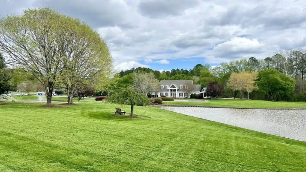 Open green lawn and pond in the Durham, NC area near O'Kelly Chapel