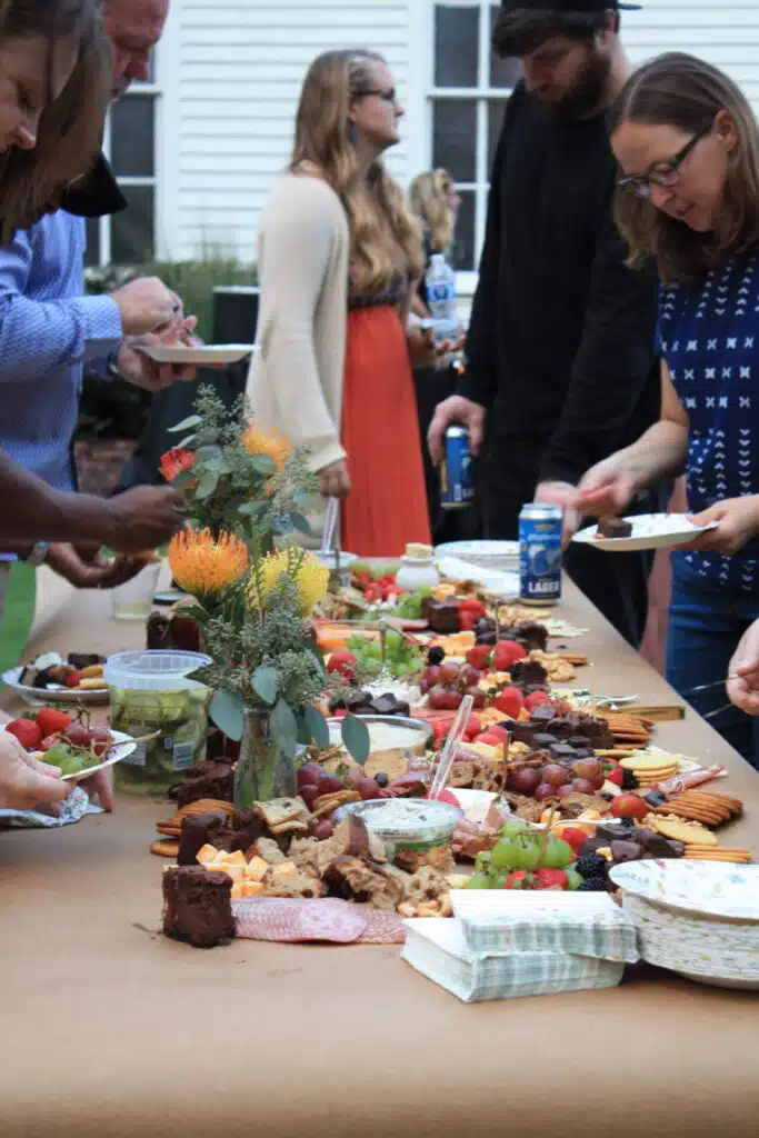 Guests serving from a grazing food table at an O'Kelly Chapel event