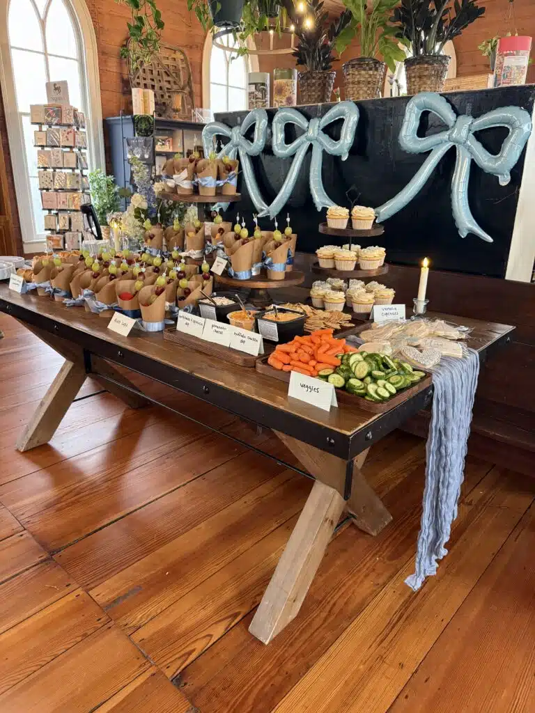 Dessert and favor table with a chalkboard sign at an O'Kelly Chapel reception