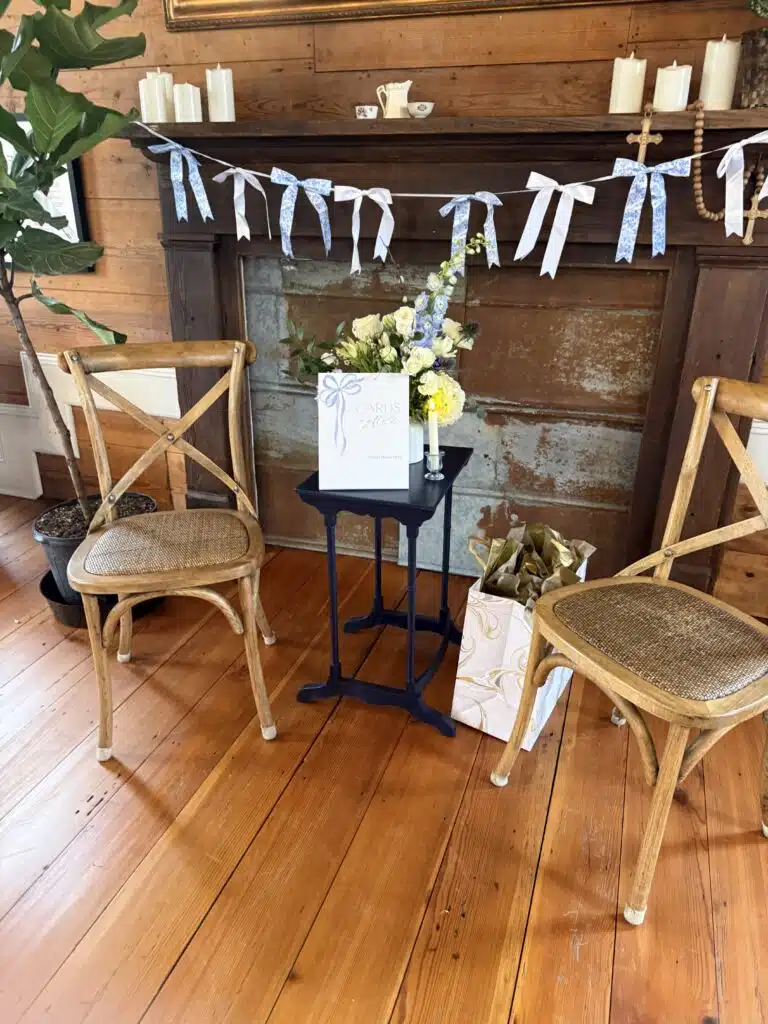 Welcome sign and florals with a ribbon garland inside O'Kelly Chapel
