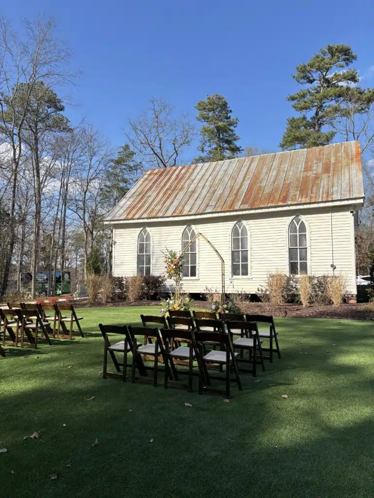 Outdoor wedding ceremony seating set up on the lawn beside O'Kelly Chapel