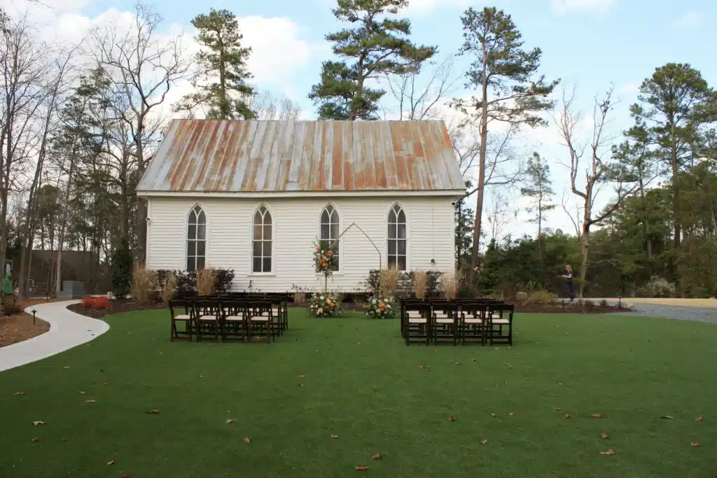 The historic O'Kelly Chapel with wedding ceremony seating on the green lawn